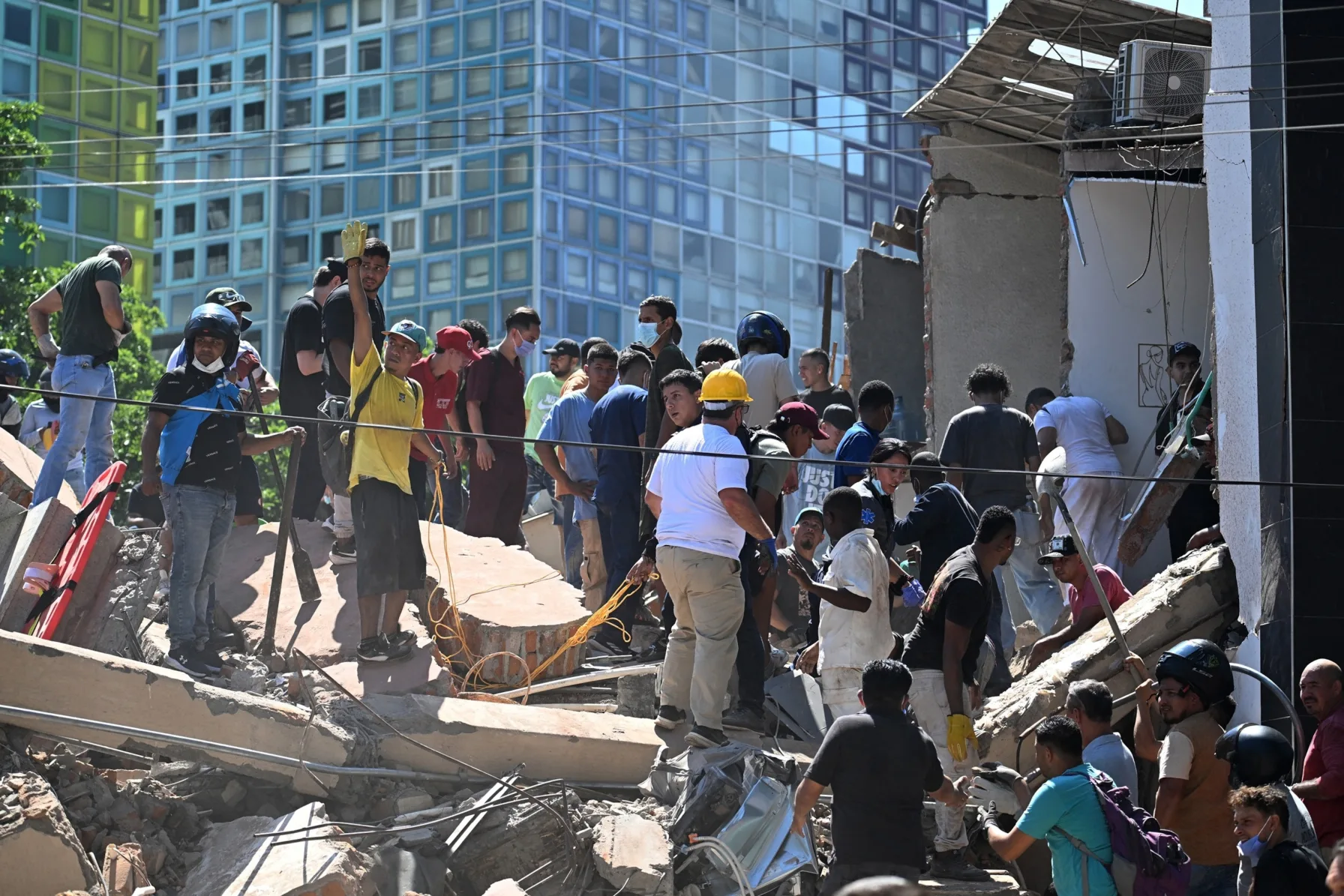 Rescue workers search rubble after a 7.4-magnitude earthquake in western Colombia