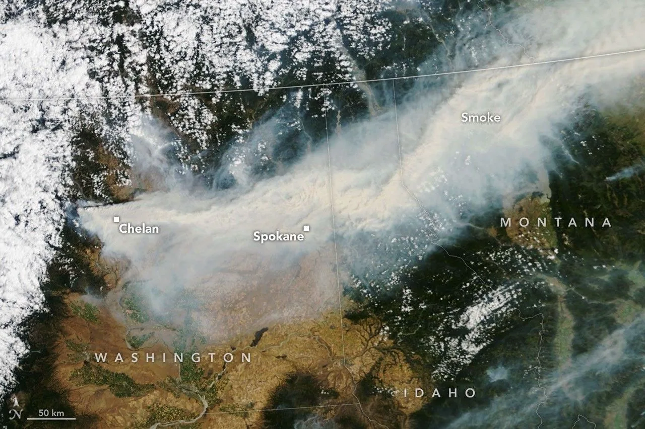NASA satellite image showing smoke streaming across Eastern Washington during the state's 2026 wildfire season
