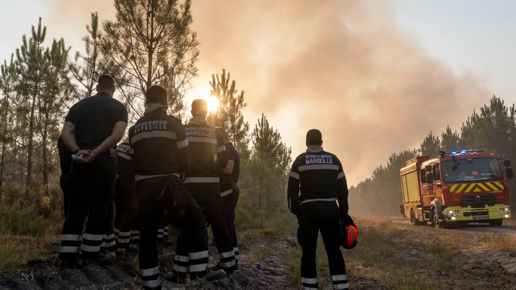 Firefighters and aircraft battling a large wildfire in southwestern Europe