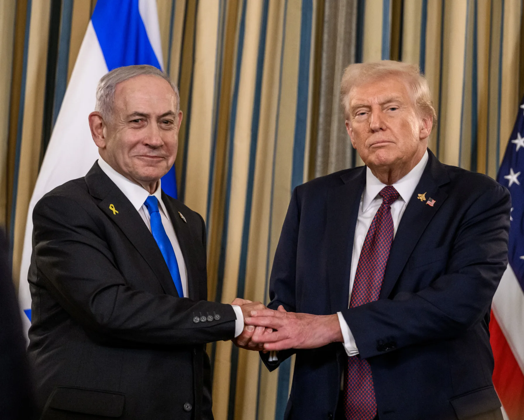President Trump and Israeli Prime Minister Benjamin Netanyahu shake hands at a joint press conference