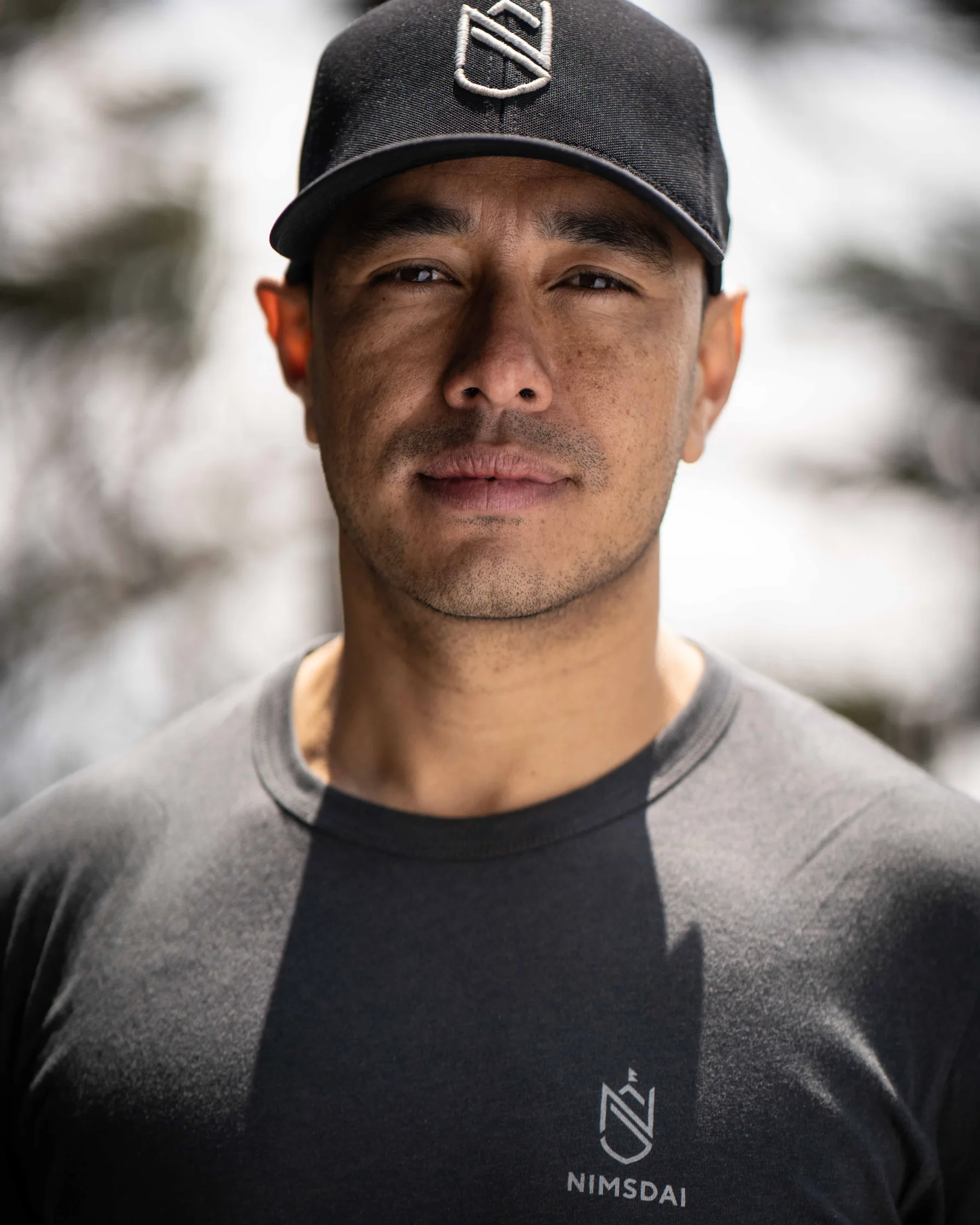 Portrait of mountaineer Nirmal 'Nimsdai' Purja wearing a cap with his Nimsdai brand logo